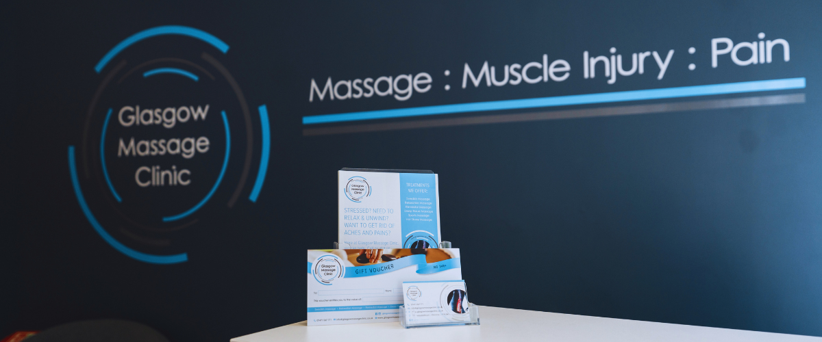 Glasgow Massage Clinic gift vouchers and treatment information displayed in the clinic reception area.