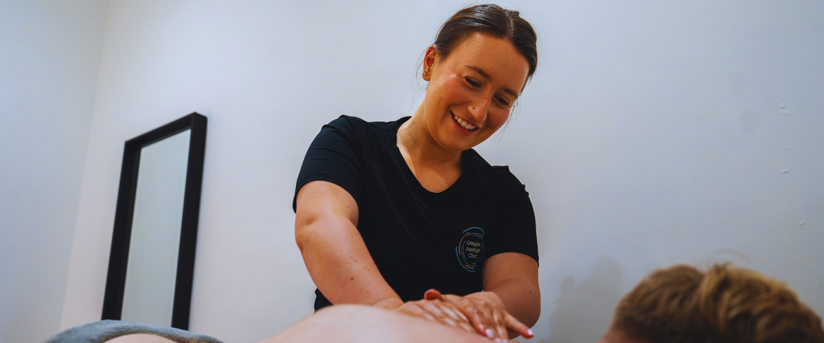 Massage therapist providing a back treatment to a client at Glasgow Massage Clinic.